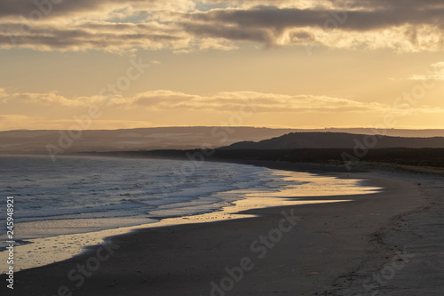 golden sunrise on river and coast scenery in lossiemouth, scotland, west coast during winter in january.