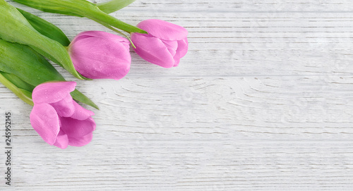 Fototapeta Naklejka Na Ścianę i Meble -  Purple tulips on wooden table