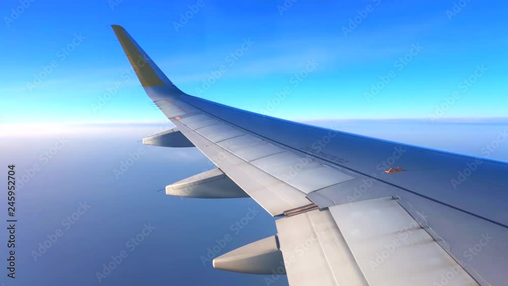 Airplane flight. Wing of an airplane flying above the clouds. View from the window of the plane. Aircraft. Traveling. 4K UHD video footage. 3840X2160 Airplane flight. Wing of an airplane flying above the clouds. View from the window of the plane. Aircraft. Traveling. 4K UHD video footage. 3840X2160