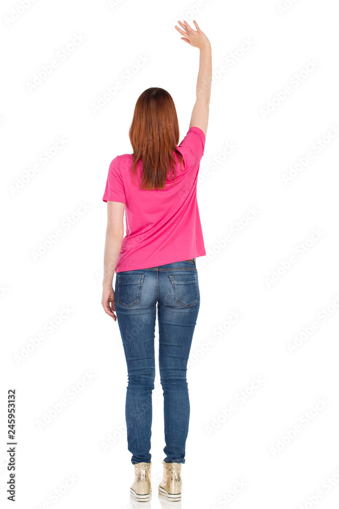 Young Woman Is Standing And Waving Hand. Rear View. Young Woman Is Standing And Waving Hand. Rear View.