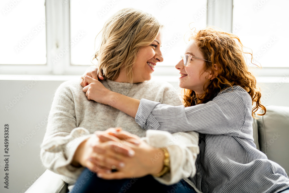 mother and daughter having good time in the living room mother and daughter having good time in the living room