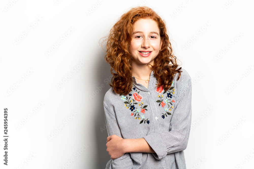 Beautiful readhead girl with on studio white background