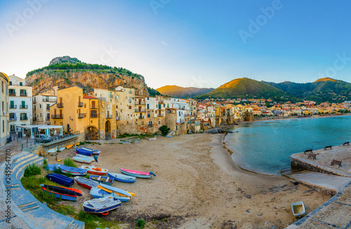 Beach of old town Cefalu with colorful boats in the morning, Sicily, Italy