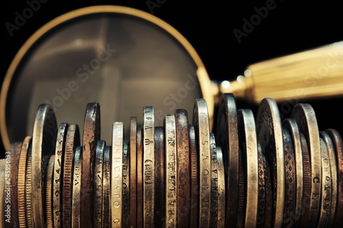 Old moneys and coins through a magnifying glass. Numismatics and collecting money.Russian Empire and world currency.Silver,gold.Coat of arms