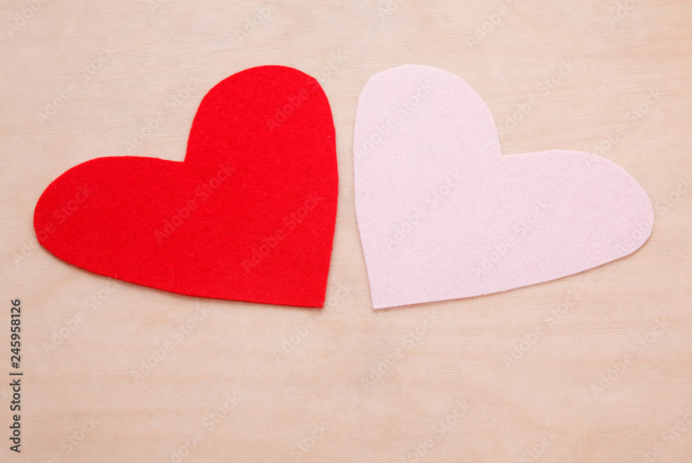 Two felt form of hearts on the wood table Two felt form of hearts on the wood table