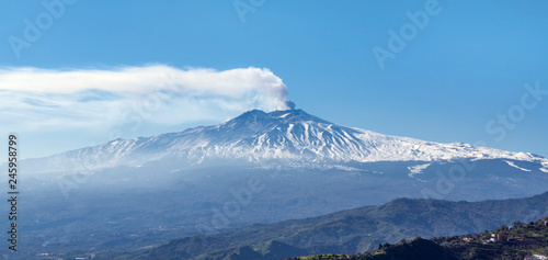 Famous volcano Etna in Sicily releasing cloud of ash