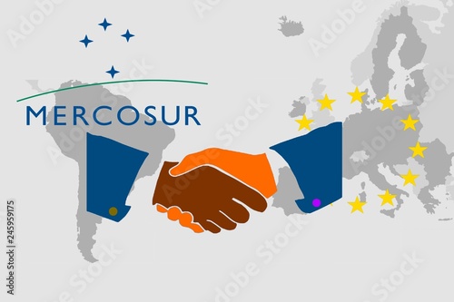 Trade agreement between Mercosur and the EU -   On the maps of South America and Europe are the respective symbols. In front of it the illustration of a handshake as a symbol for a contract. photo