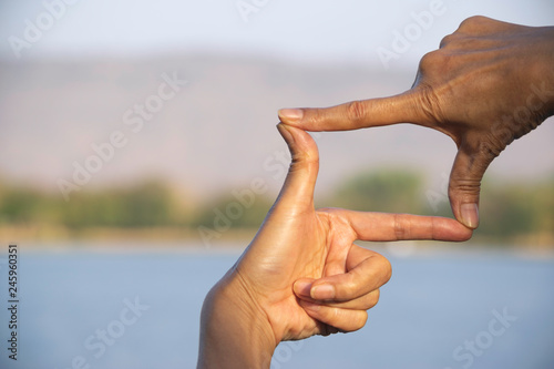 Photography Hands of person making frame distance or symbol in nature.