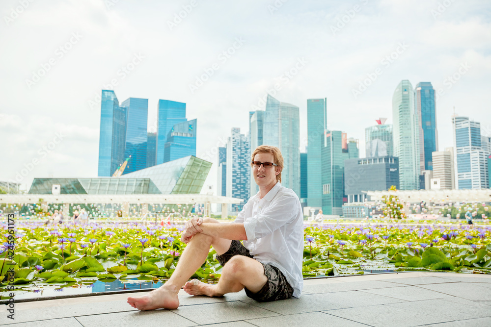 man in Singapore on the background of skyscrapers