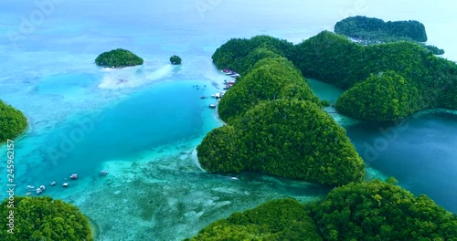 Aerial view flying over the beautiful and tropical green mountains Sugba Lagoon in Siargao, Philippines photo