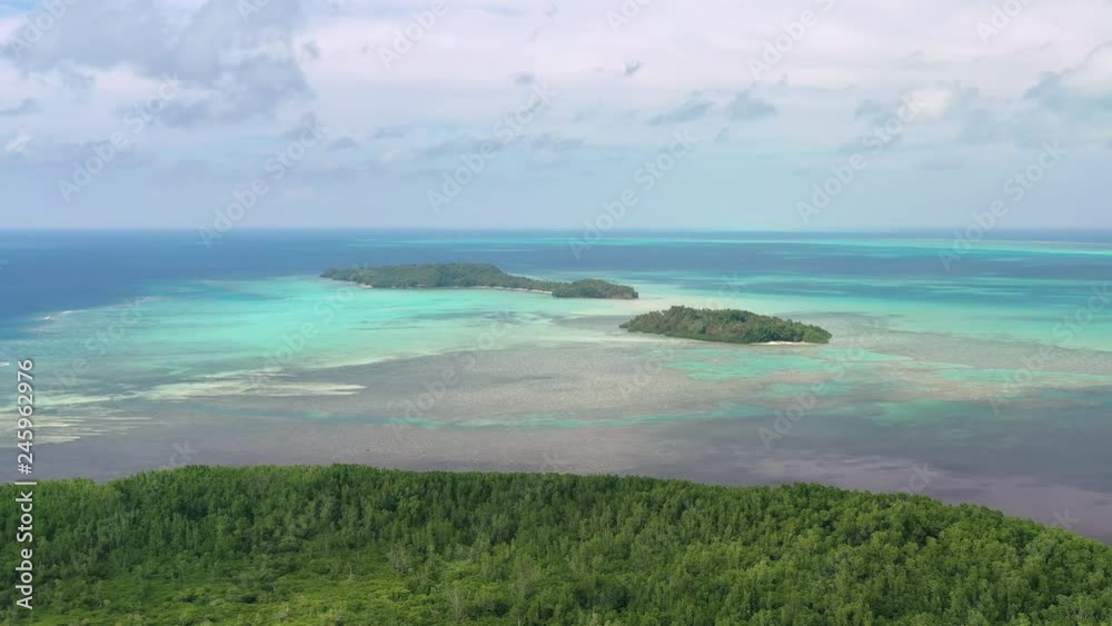 Aerial view of islets Ngerechur and Ngerkeklau, crystal clear waters of Pacific Ocean, seascape with colorful coral reefs, many shades of turquoise and blue - landscape panorama of Micronesia, Palau Aerial view of islets Ngerechur and Ngerkeklau, crystal clear waters of Pacific Ocean, seascape with colorful coral reefs, many shades of turquoise and blue - landscape panorama of Micronesia, Palau