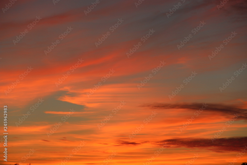 Orange sunset before night. Twilight with bright sunset. Evening landscape