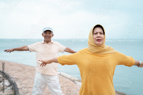 couple asian muslim stretching and exercising together