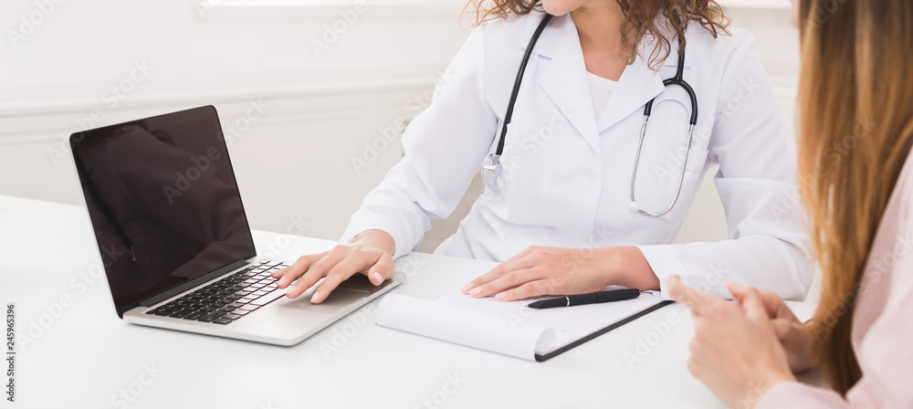 Doctor using laptop in office, making patient's anamnesis Doctor using laptop in office, making patient's anamnesis