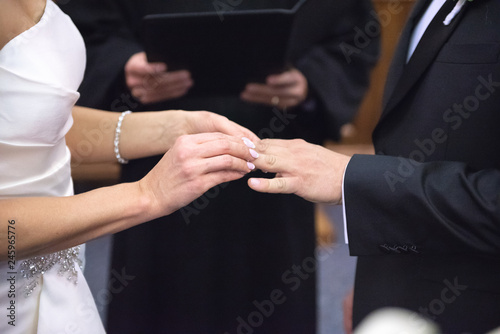 A bride and groom exchange rings 