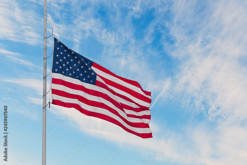 American flag on the sunset sky background