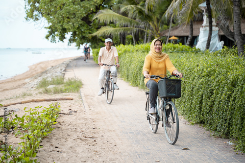 old couple ride bicycle together