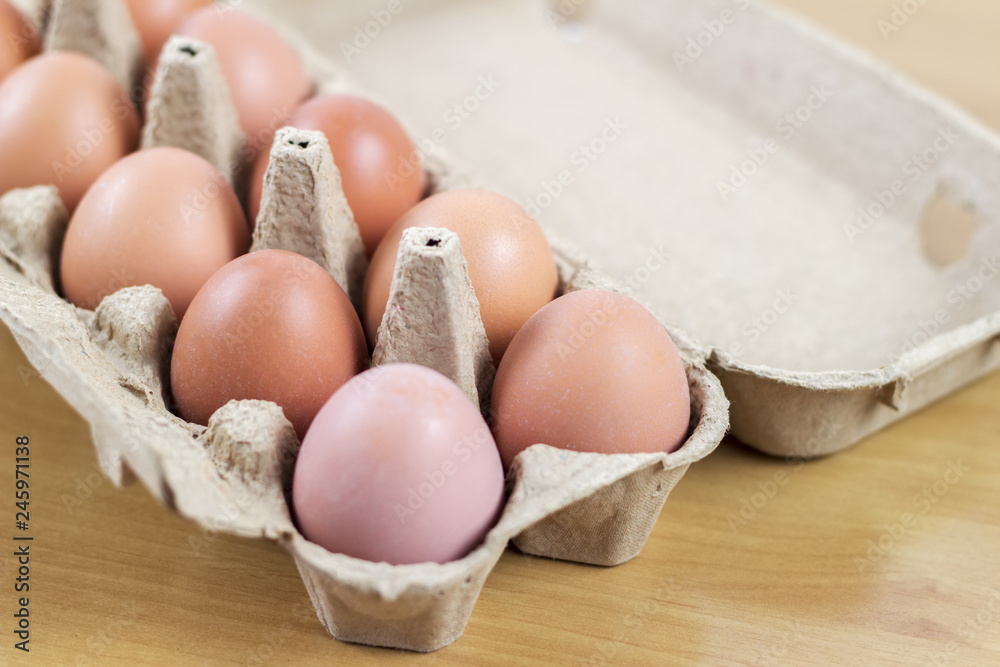 Overhead view of brown chicken eggs in an open egg carton. Fresh chicken eggs background. Overhead view of brown chicken eggs in an open egg carton. Fresh chicken eggs background.