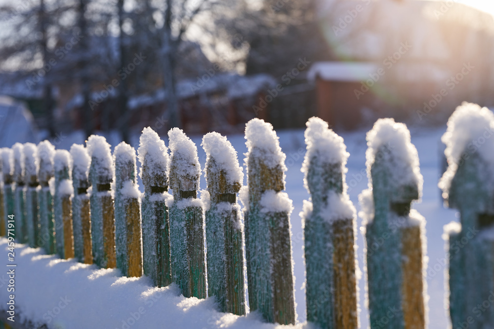 Fototapeta premium Snow on the elements of a wooden fence