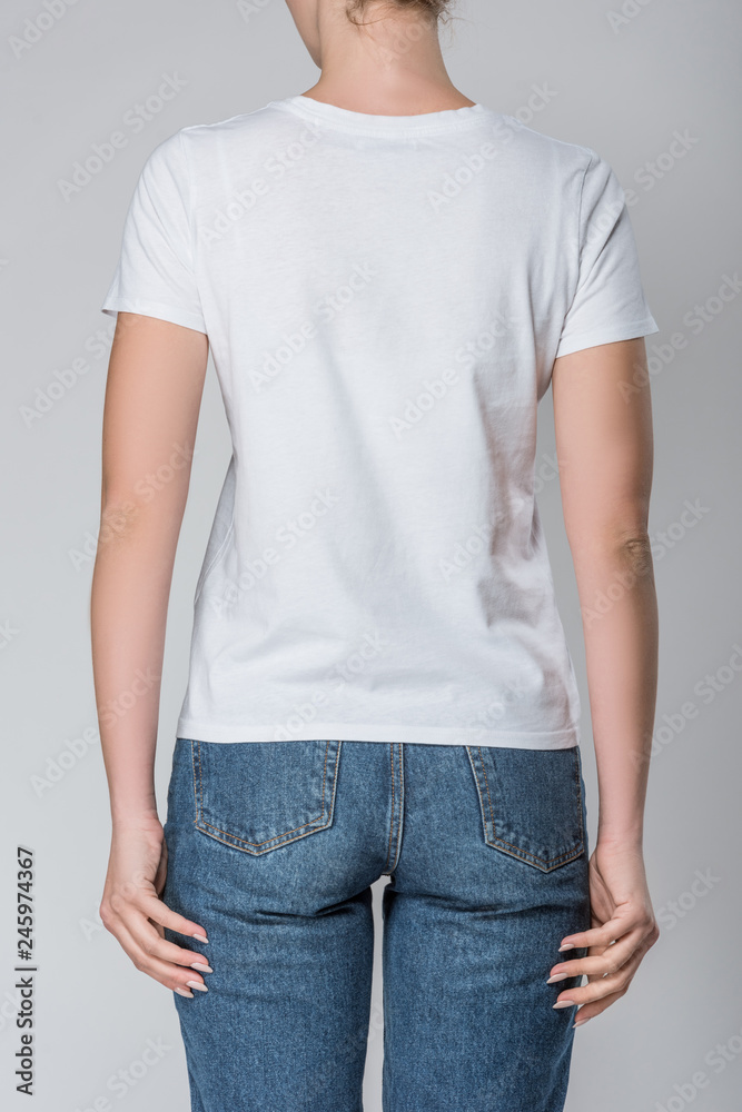 back view of woman posing in white t-shirt with copy space, isolated on grey back view of woman posing in white t-shirt with copy space, isolated on grey