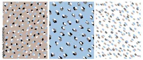 Set of 3 Cute Abstract Dots Vector Pattern. White, Black and Light Brown Irregular Brush Dots on a White, Beige and Blue Backgrounds. Lovely Pastel Color Delicate Layouts. Abstract Wild Animal Skin.