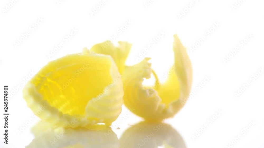Butter. Curls of fresh natural butter rotated on a white background. 4K UHD video footage. 3840X2160 Butter. Curls of fresh natural butter rotated on a white background. 4K UHD video footage. 3840X2160