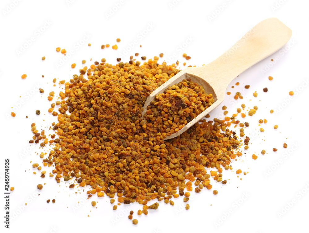 Bee pollen in wooden spoon macro isolated on white background Bee pollen in wooden spoon macro isolated on white background