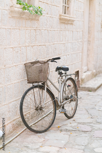 old rusty vintage bicycle leaning against a stone wall