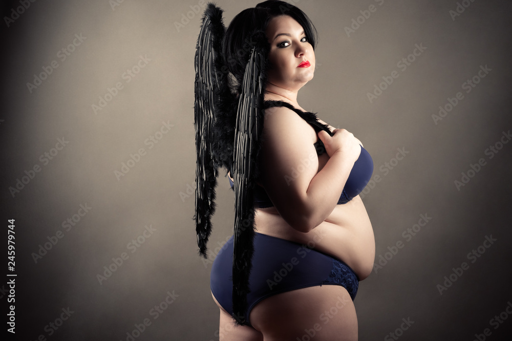 fat woman in lingerie with black wings Stock Photo