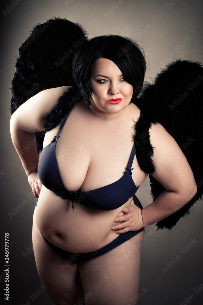 sensual fat woman in black lingerie with black wings Stock Photo