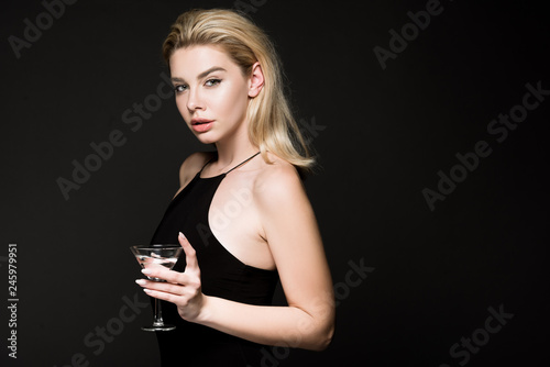 elegant woman girl in black dress posing with cocktail glass isolated on black