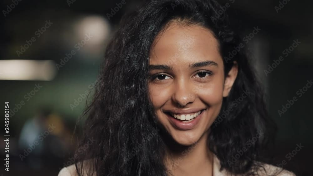Attractive young woman looking into the camera smiling feel happy in cozy cafe close up Attractive young woman looking into the camera smiling feel happy in cozy cafe close up