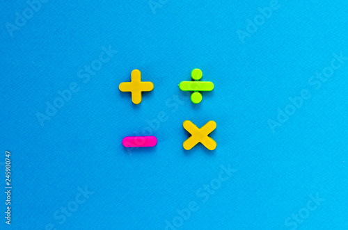фотографія plus, minus, divide, multiply on blue background