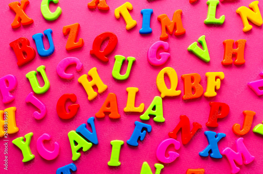 Fototapeta premium colored letters on pink background