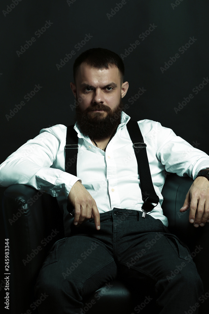 young handsome man with big beard on black background close up portrait young handsome man with big beard on black background close up portrait