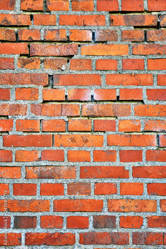 Obraz premium Brick wall background vertical with broken stones.