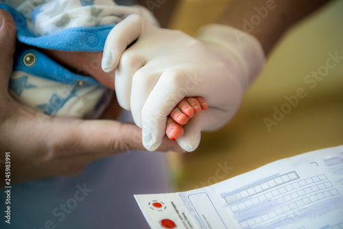 doctor takes a blood test in newborns