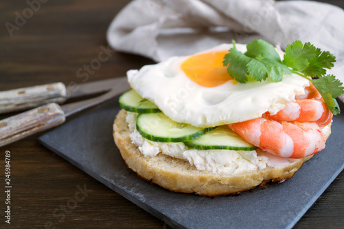 egg and cucumber sandwich on wooden background.