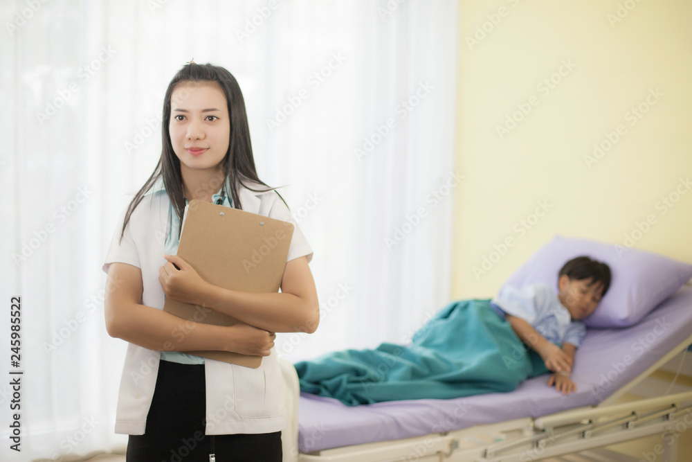 Asian woman doctor are take care boy patient are sleep on the bed in hospital, healthcare and medical concept image Asian woman doctor are take care boy patient are sleep on the bed in hospital, healthcare and medical concept image