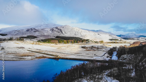Snow covered Scottish mountains and lochs, an aerial veiw over the river Spey in Scotland