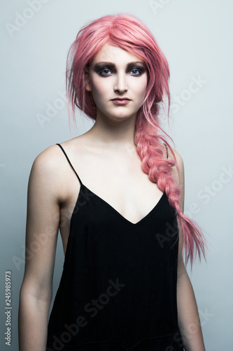 Portrait of young woman with braided pink hair