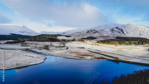 Snow covered Scottish mountains and lochs, an aerial veiw over the river Spey in Scotland