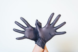 Abstract gestures with their hands in black gloves.