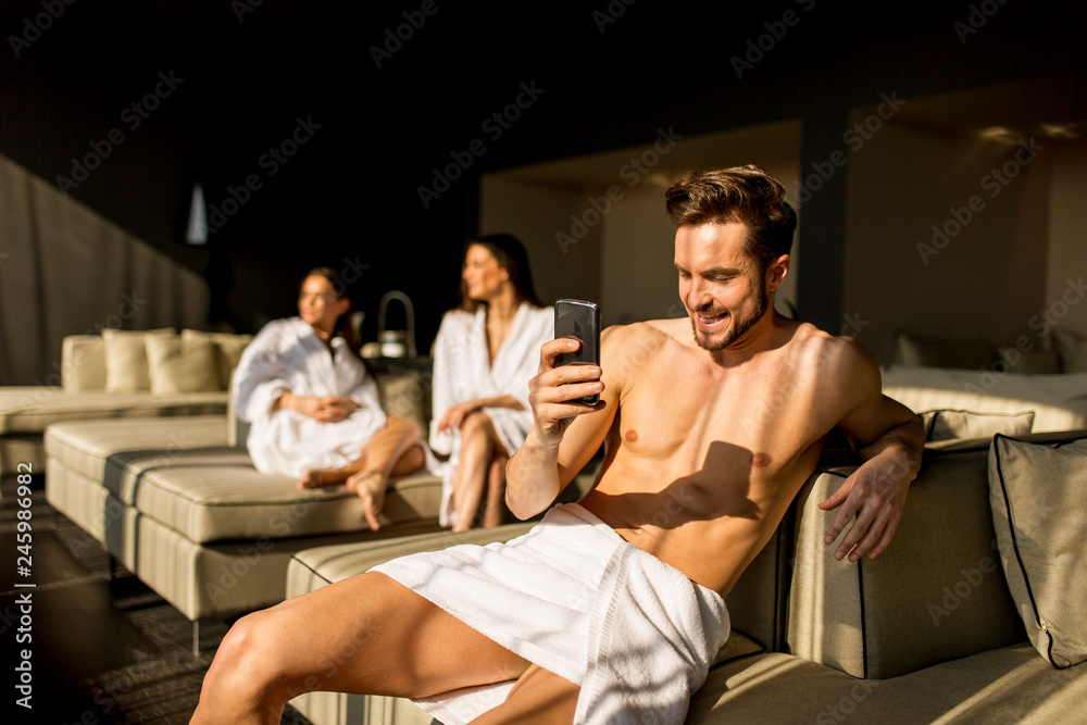 Young man in the room with mobile phone Young man in the room with mobile phone
