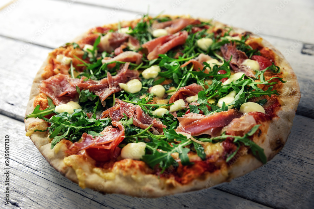 prosciutto pizza with mozzarella cheese and arugula