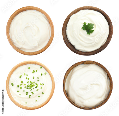 Set of delicious sour cream in bowls on white background, top view