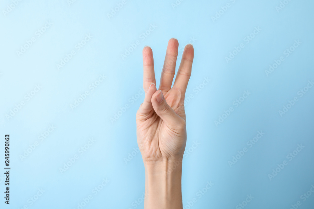 Woman showing number six on color background, closeup. Sign language Woman showing number six on color background, closeup. Sign language