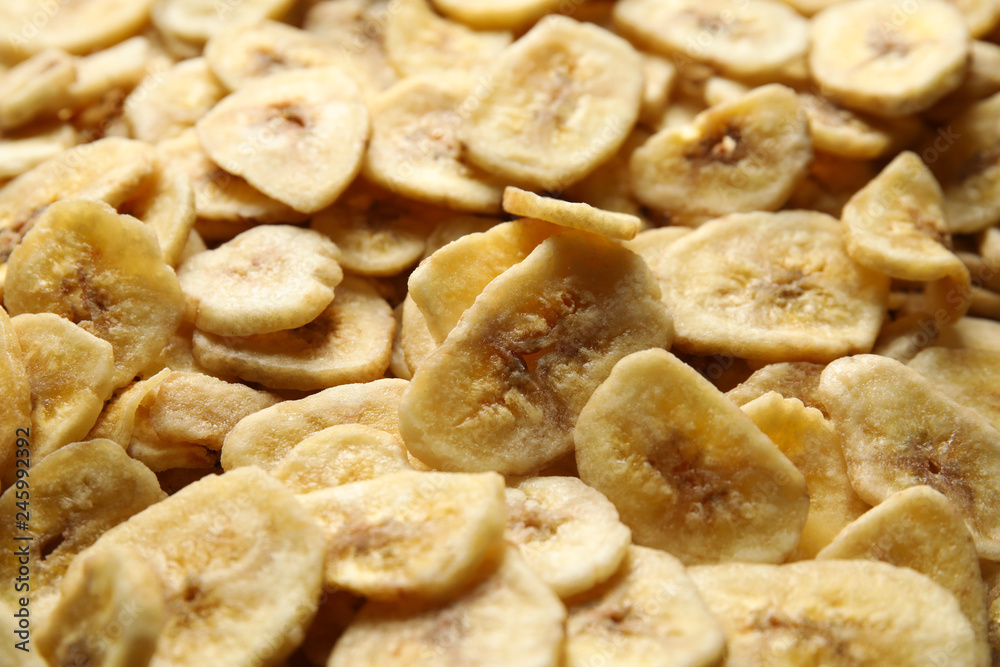 Sweet banana slices as background. Dried fruit as healthy snack