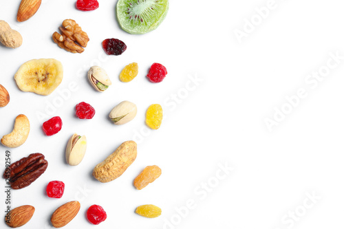 Flat lay composition of different dried fruits and nuts on white background. Space for text
