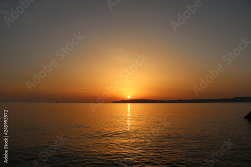 sunset at sea above island Malta © Lau
